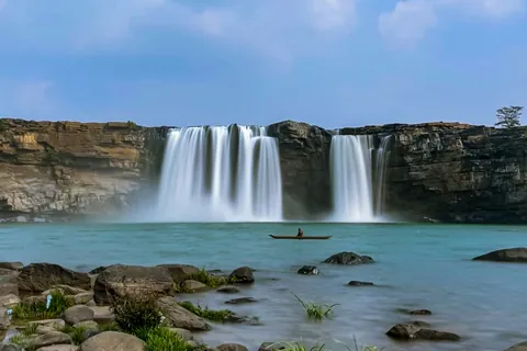 Chitrakote Falls on the Indravati River with a boatman on the water