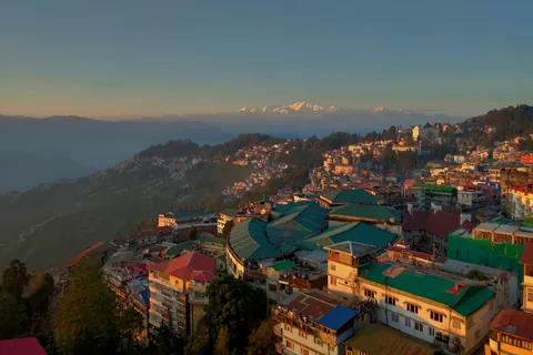 Rooftops of Darjeeling at sunrise with the Kanchenjunga range on the horizon