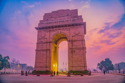 India Gate under a pink and purple sky, New Delhi
