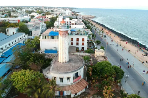 Aerial view of the old lighthouse and the seafront promenade with strollers, Puducherry
