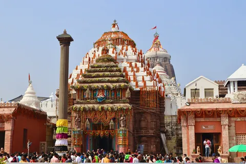 The Jagannath Temple in Puri decorated with marigold garlands, with devotees gathered at the entrance